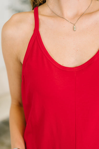 Red tank top worn by a person with a blurred background
