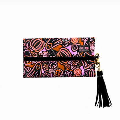 Colorful patterned clutch with a tassel on a white background