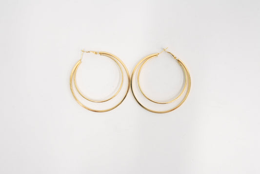 A pair of gold-toned double-hoop earrings on a clean white background.