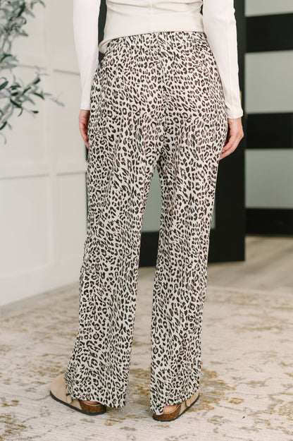 Leopard print pants worn by a person in an indoor setting