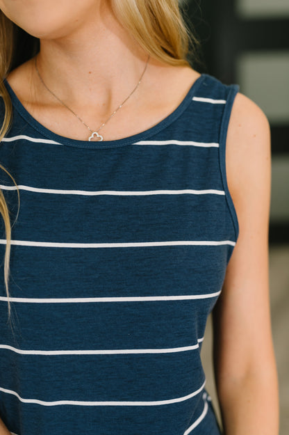 Navy blue tank top with white stripes worn by a person.