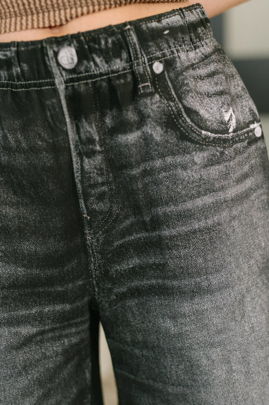 Close-up of black jeans with a blurred background