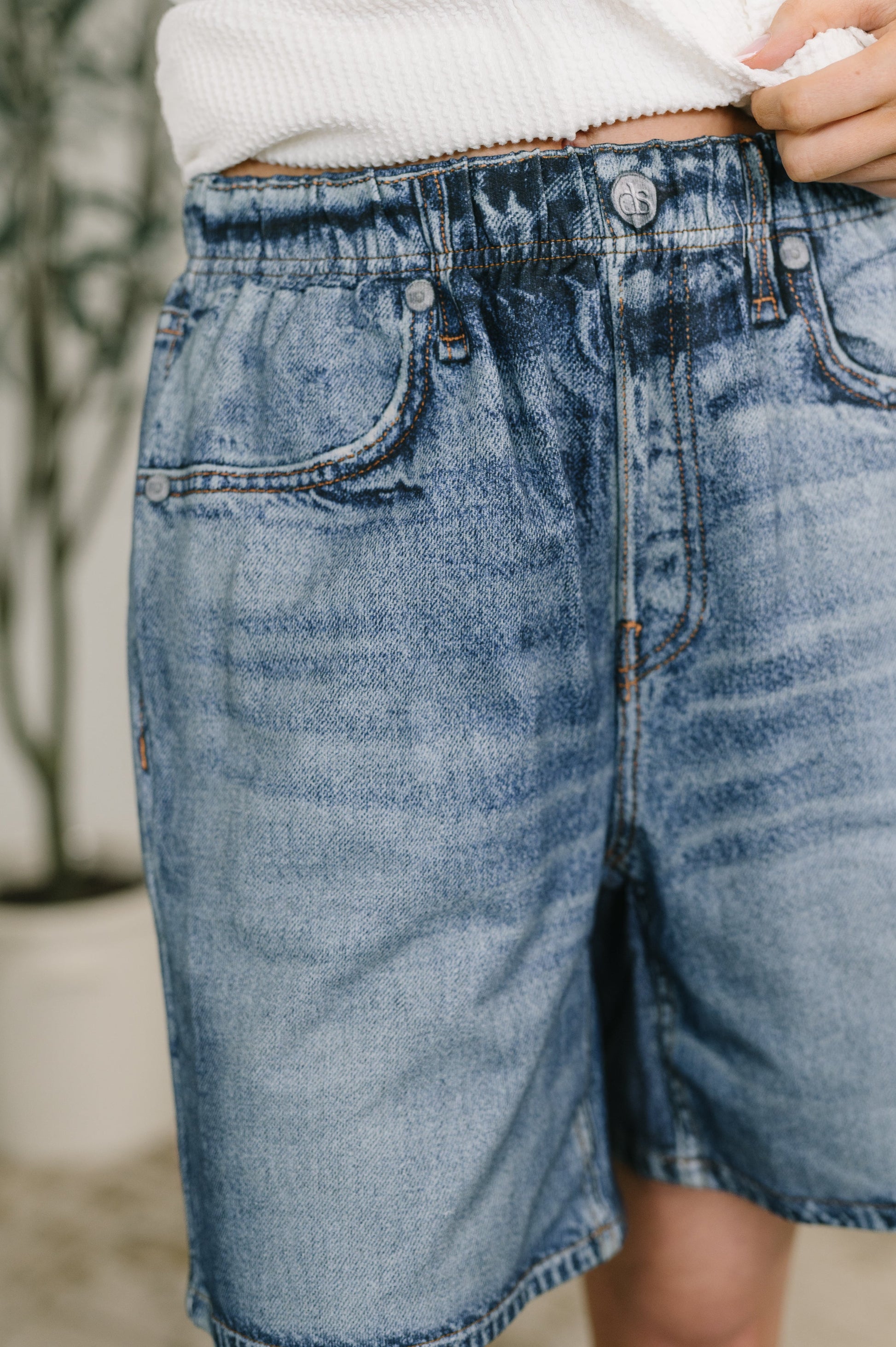 Close-up of blue denim shorts with a blurred background