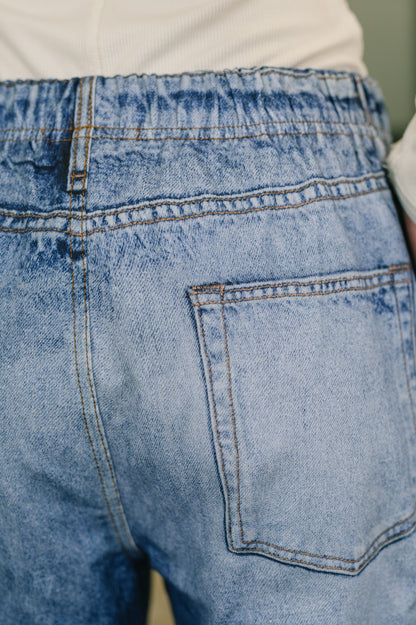Close-up of blue denim jeans with a pocket detail.