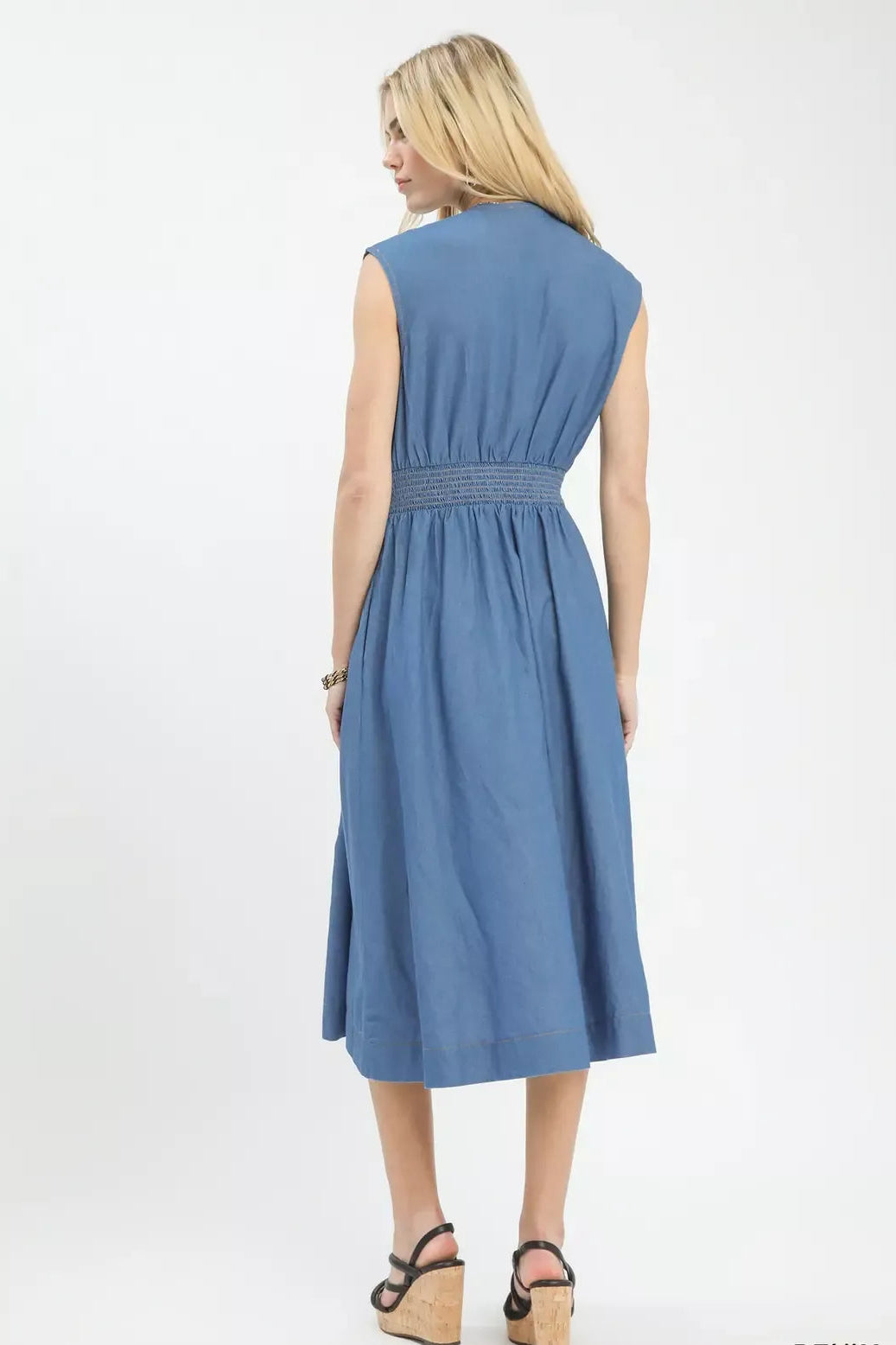 Woman wearing a blue dress on a white background