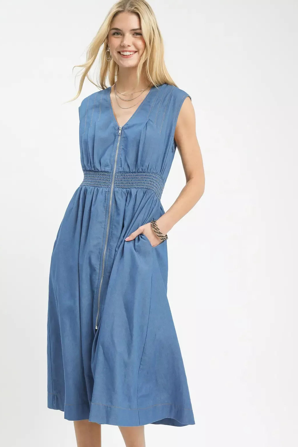 Woman wearing a blue denim dress on a white background
