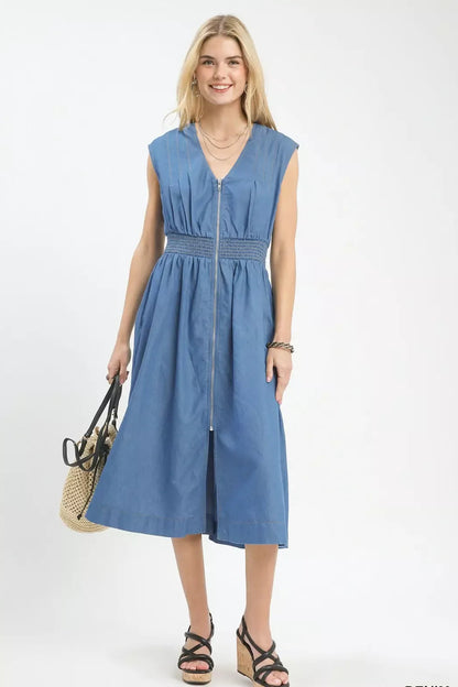 Woman wearing a blue denim dress on a white background