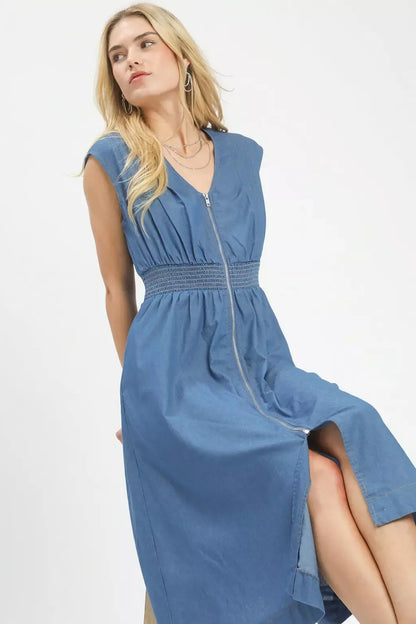 Woman wearing a blue dress with a white background