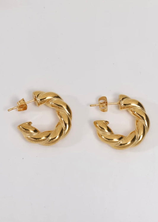 Gold hoop earrings on a white background