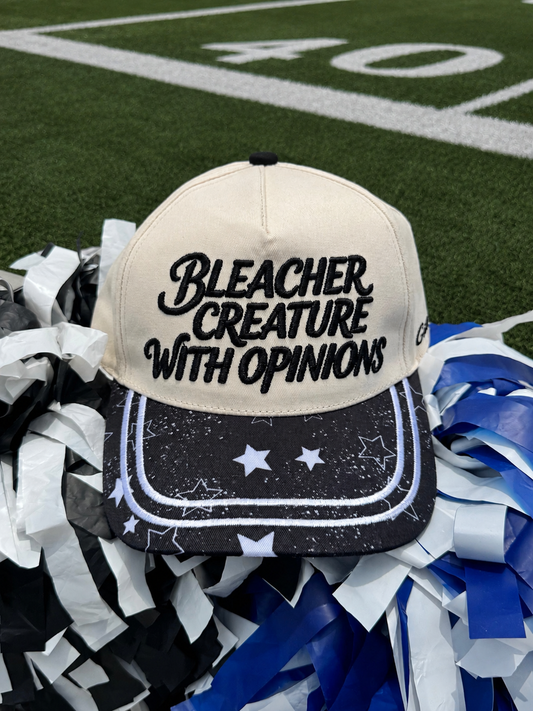 Beige cap with 'Bleacher Creature with Opinions' text on a football field background
