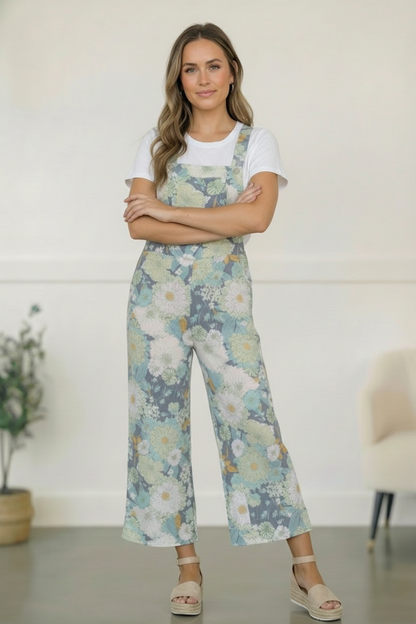 Woman wearing floral overalls with a white background