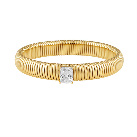 Gold bracelet with a central diamond on a white background