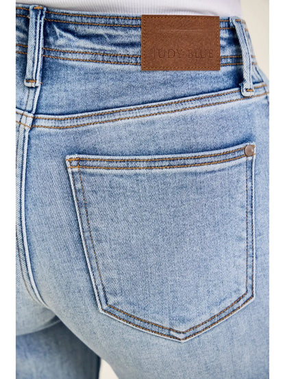 Close-up of blue jeans with a brown label on the back pocket.