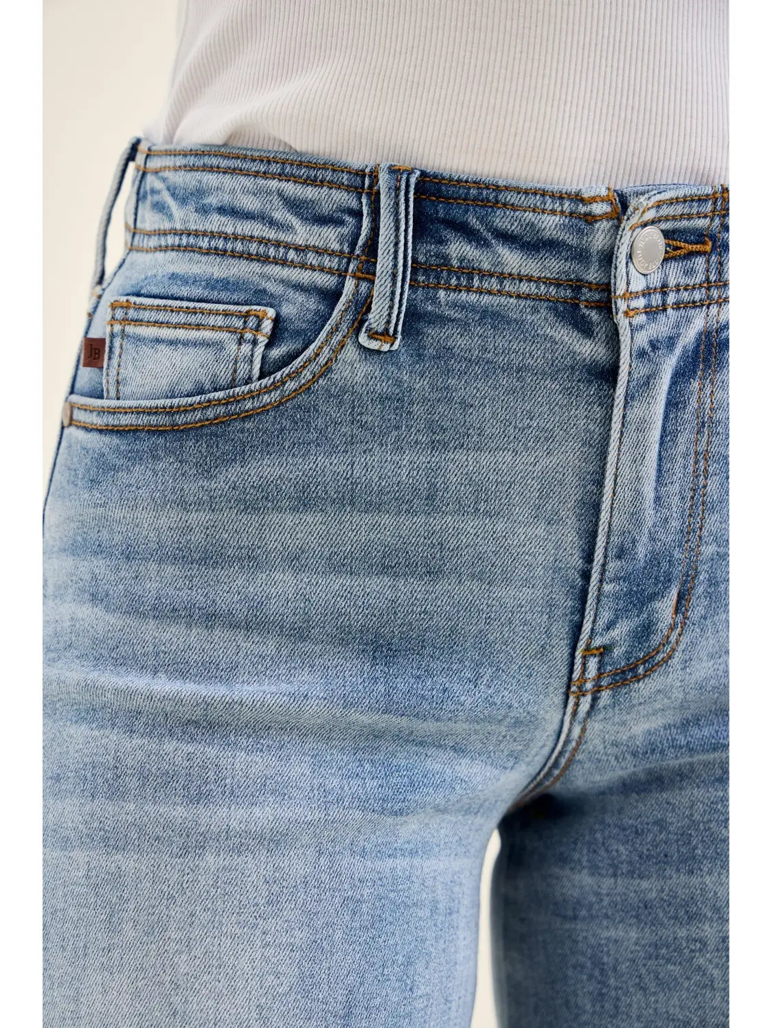 Close-up of blue jeans with a white background