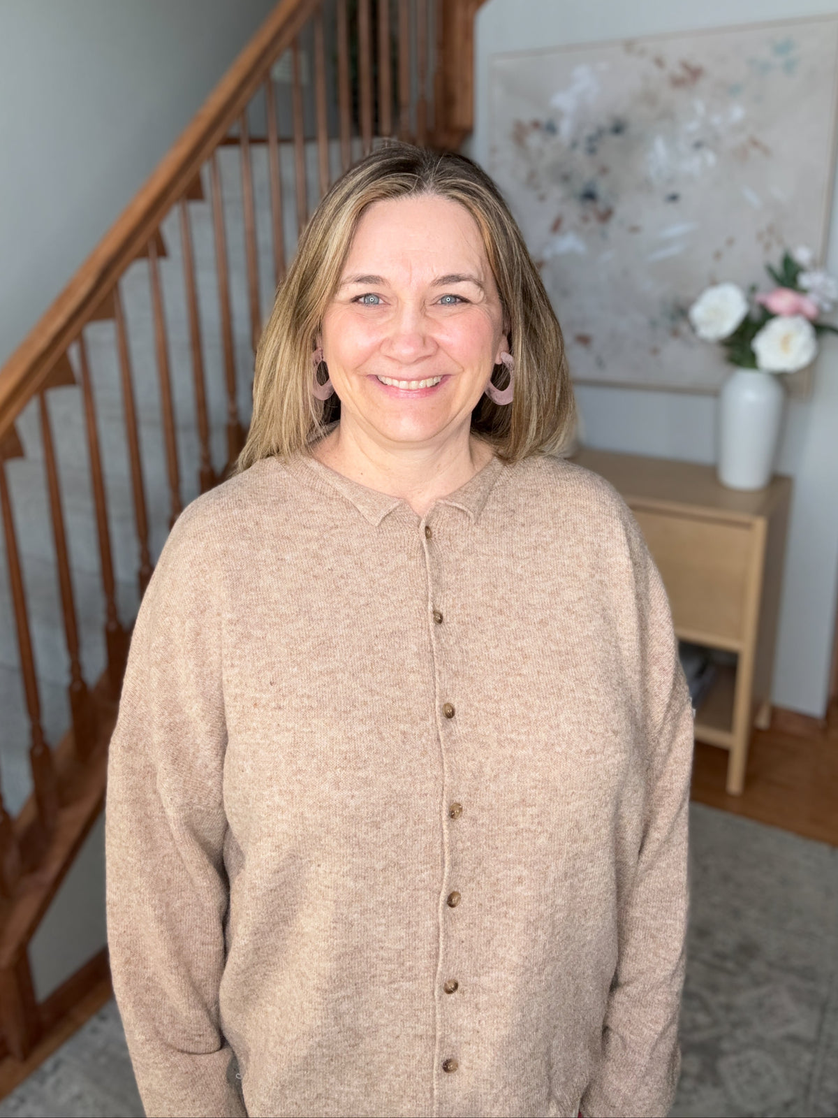 women wearing a neutral brown button up cardigan