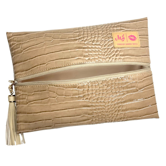 A beige faux-crocodile leather clutch pouch with a horizontal zipper, featuring a cream tassel on the left and a small yellow brand label on the top right.