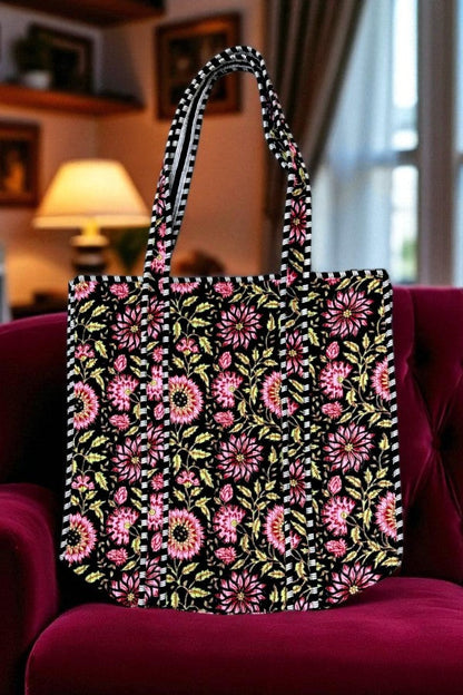 Floral-patterned tote bag on a red chair with a blurred indoor background