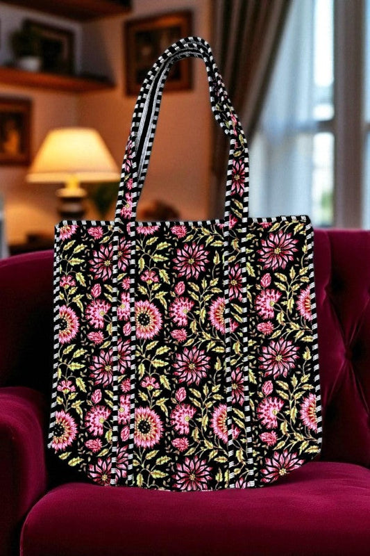 Floral-patterned tote bag on a red chair with a blurred indoor background