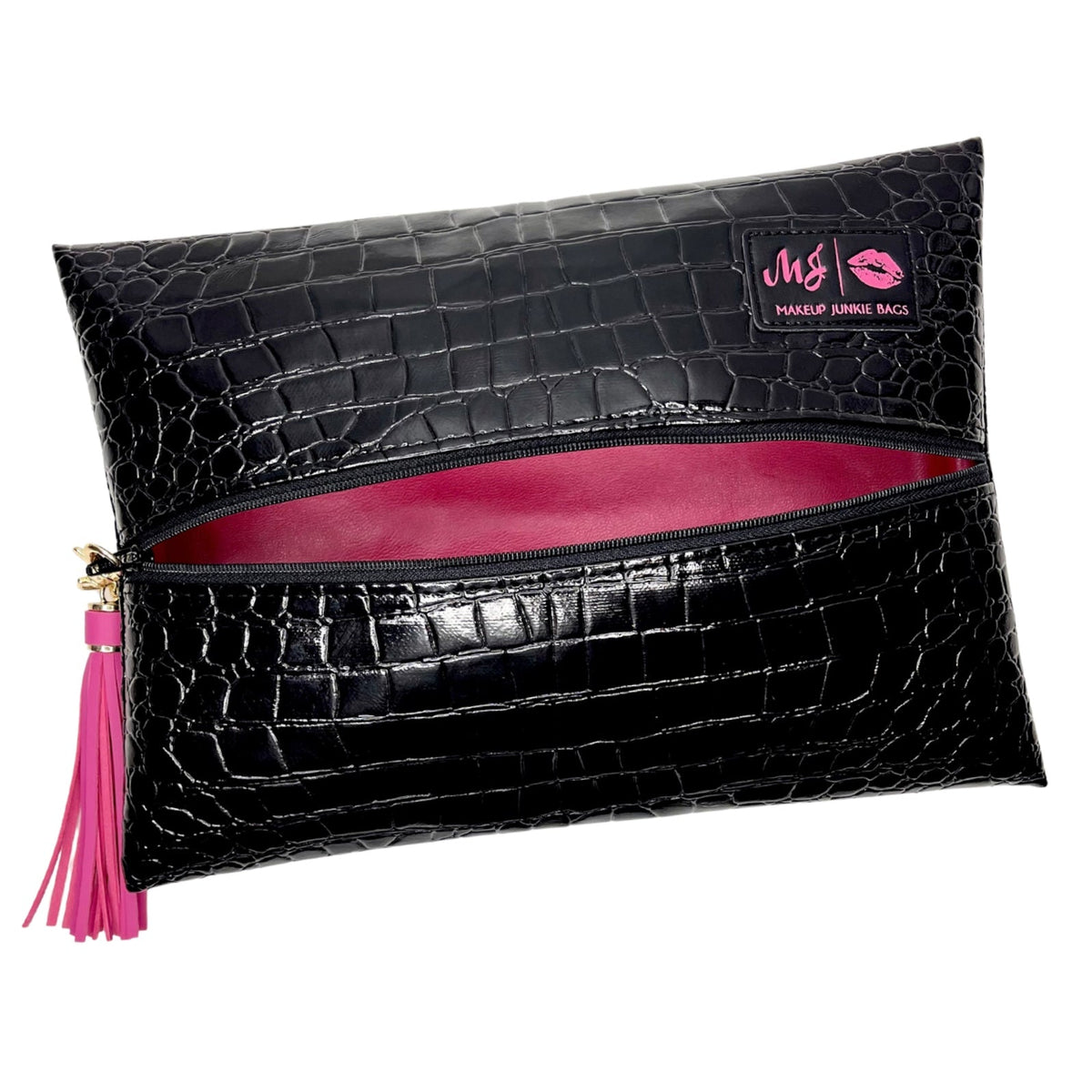 Black crocodile-embossed makeup pouch with a pink interior lining, a pink tassel zipper pull, and a pink brand patch on the top right.