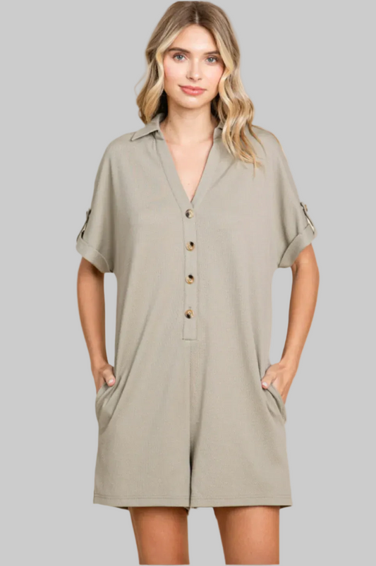 Woman wearing a beige dress with button details on a white background