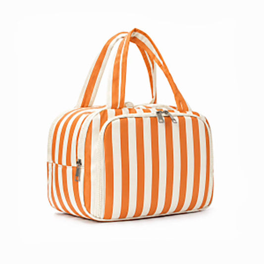 A zippered cosmetic bag with orange and white vertical stripes, featuring dual top handles and silver zipper pulls, shown on a plain white background.