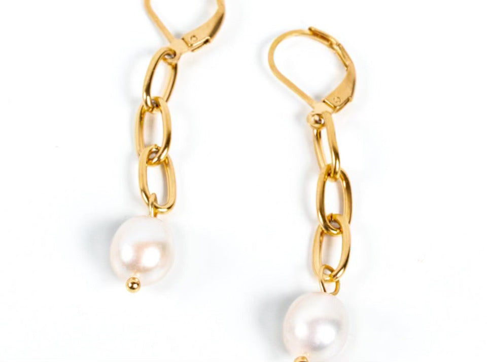 Gold chain earrings with pearls on a white background