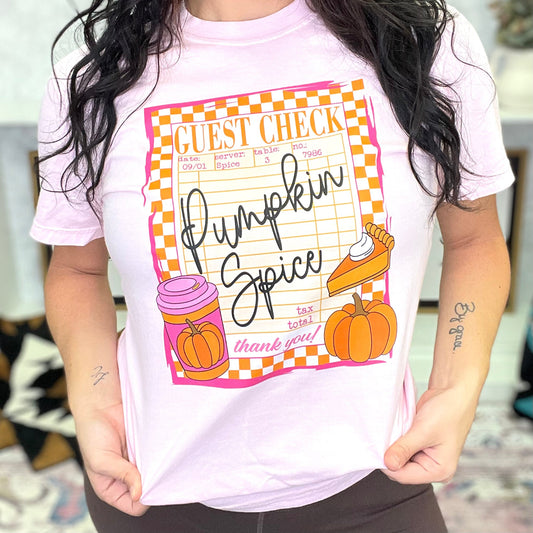 Person wearing a white t-shirt with 'Pumpkin Spice' graphic design.