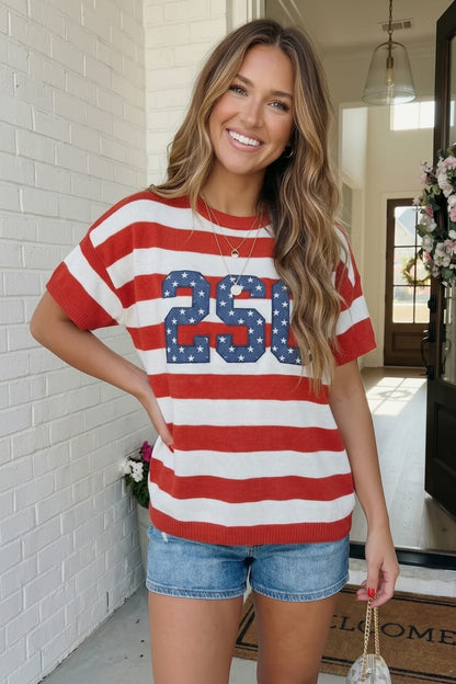 Woman wearing a red, white, and blue striped t-shirt with '250' design, standing in a home setting.