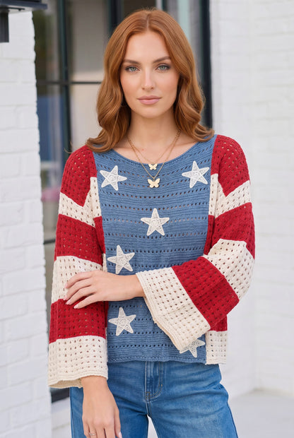 Woman wearing a colorful star-patterned sweater against a white brick wall.