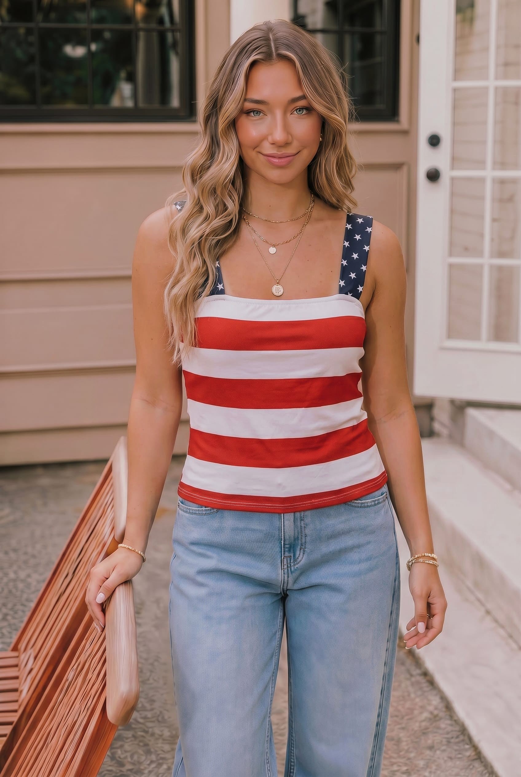 Woman wearing a red, white, and blue striped tank top with an American flag design.