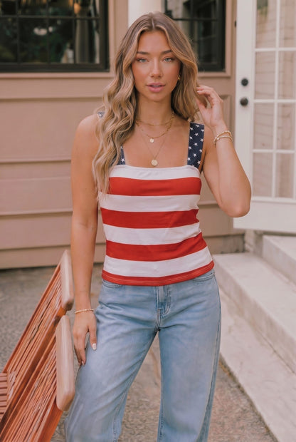 Woman wearing a red, white, and blue striped tank top with an American flag design.