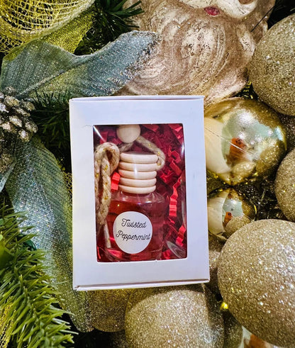 car diffuser bottle in a box with Christmas decorations around it