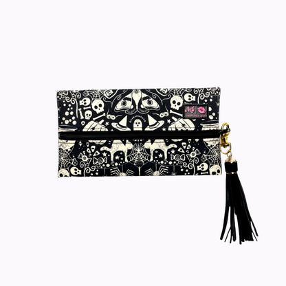 Black and white patterned pouch with tassel on a white background