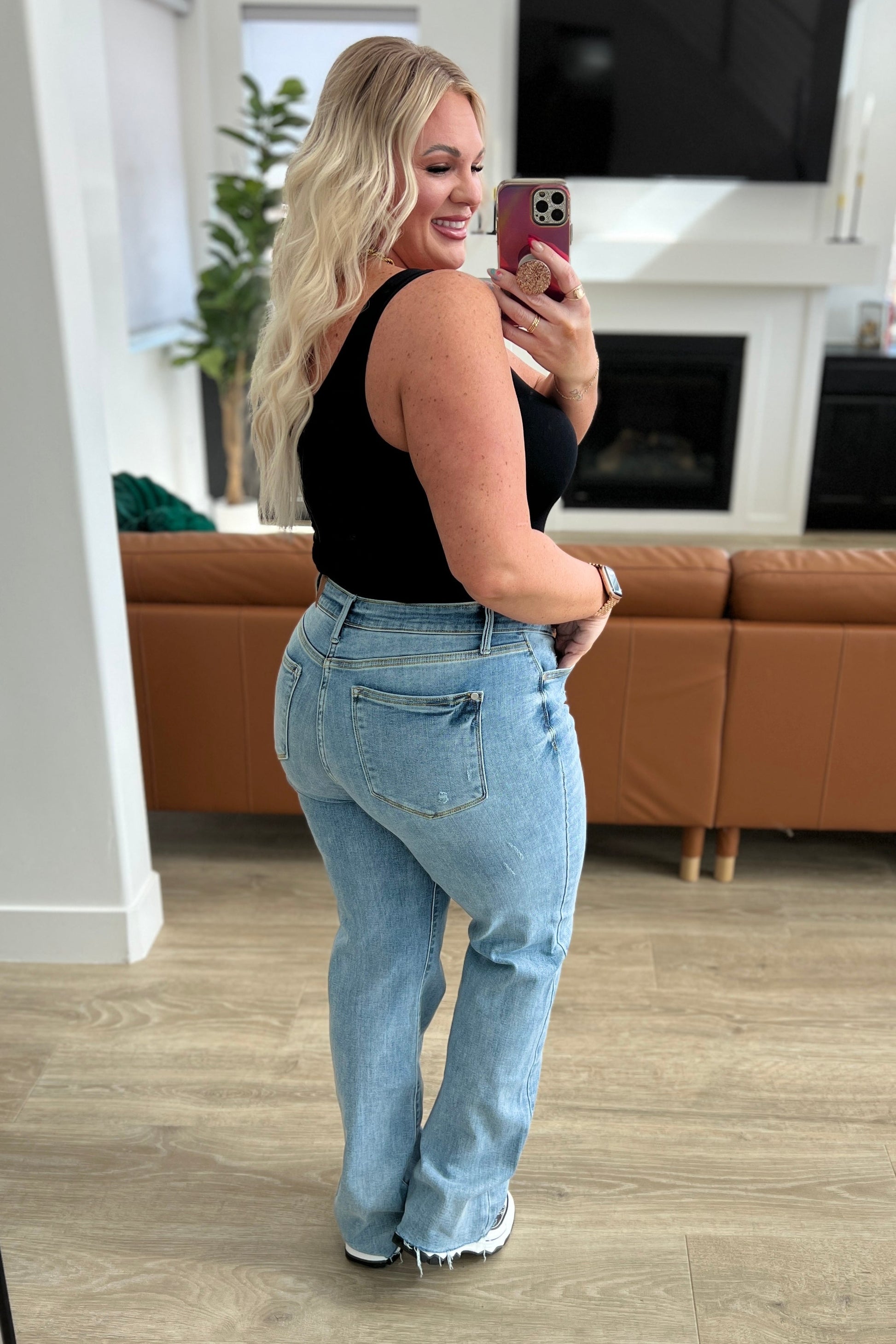  Mildred High Rise V Front Waistband Straight Jeans from Judy Blue! Back view on a woman in a black tank in a family room setting.